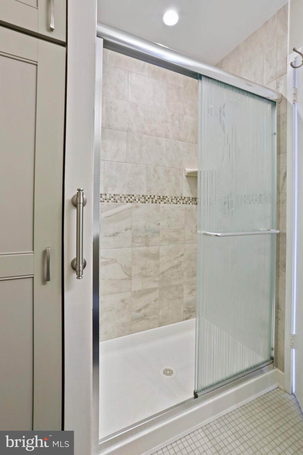 1644 Wainwright Drive Reston, VA 20190 - Photo 20 of 38 a bathroom with a glass shower door