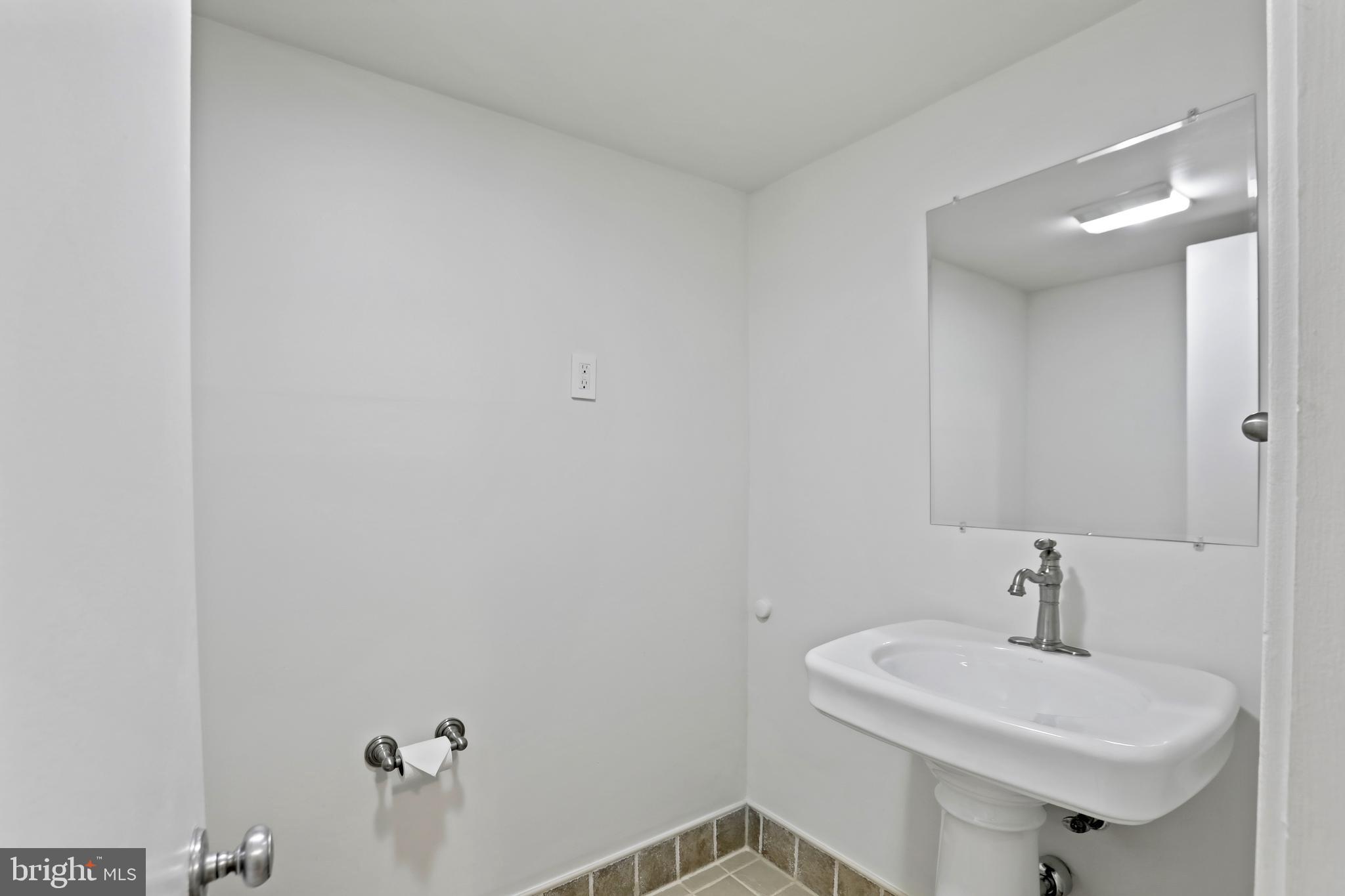 1644 Wainwright Drive Reston, VA 20190 - Photo 27 of 38 a bathroom with a sink and a toilet