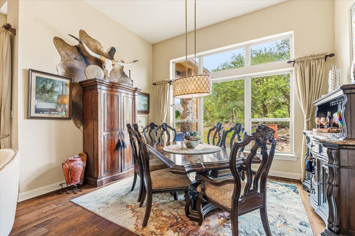 1930 Rothschild New Braunfels, TX 78132 - Photo 16 of 39 This dining area features large windows offering views of the outdoors, hardwood flooring, and a decorative chandelier