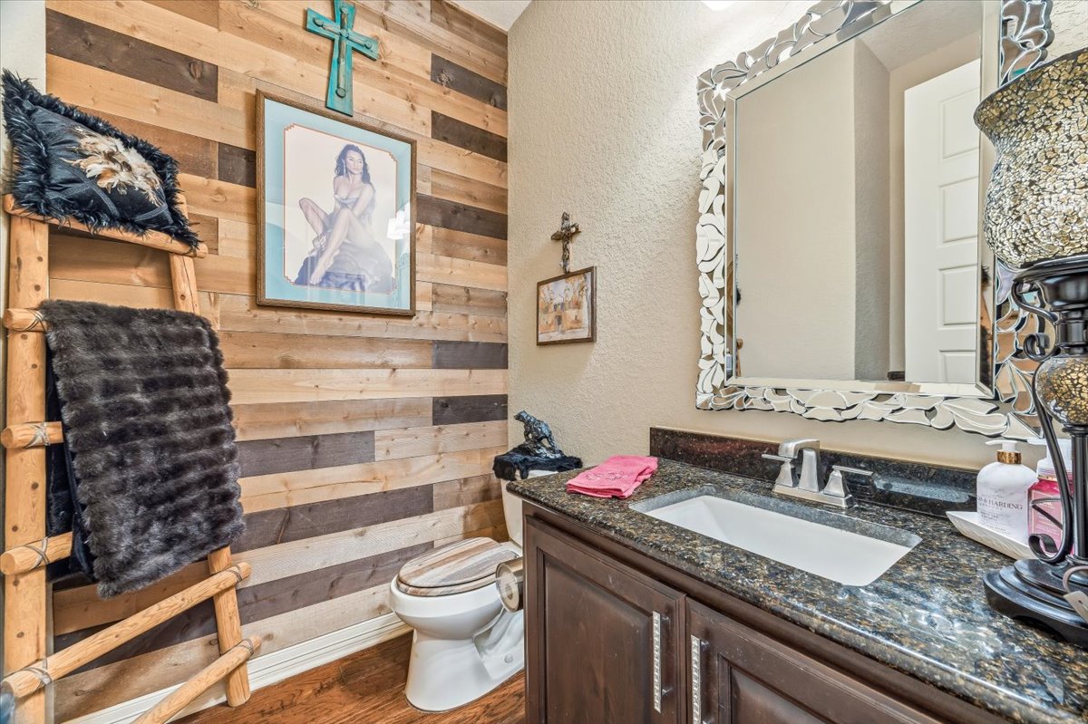 1930 Rothschild New Braunfels, TX 78132 - Photo 19 of 39 This restroom features a vanity with a dark granite countertop and a white undermount sink