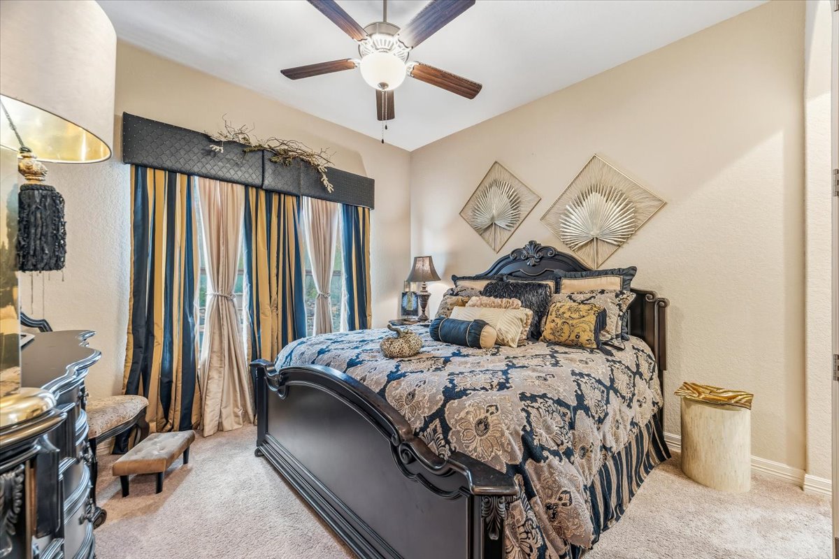 1930 Rothschild New Braunfels, TX 78132 - Photo 20 of 39 This bedroom features a ceiling fan with integrated lighting, neutral-toned walls, and carpeted flooring