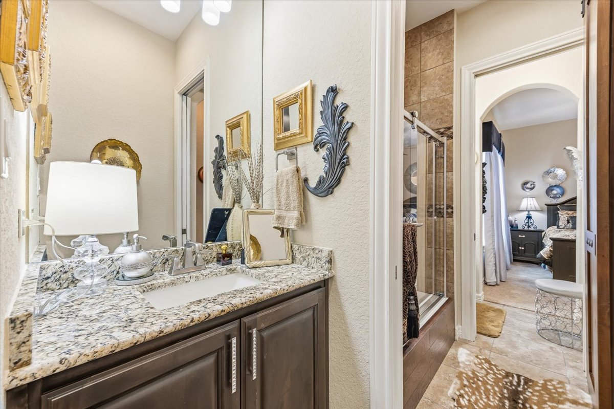 1930 Rothschild New Braunfels, TX 78132 - Photo 21 of 39 Bathroom featuring a vanity with a granite countertop, a single sink, and dark wood cabinetry