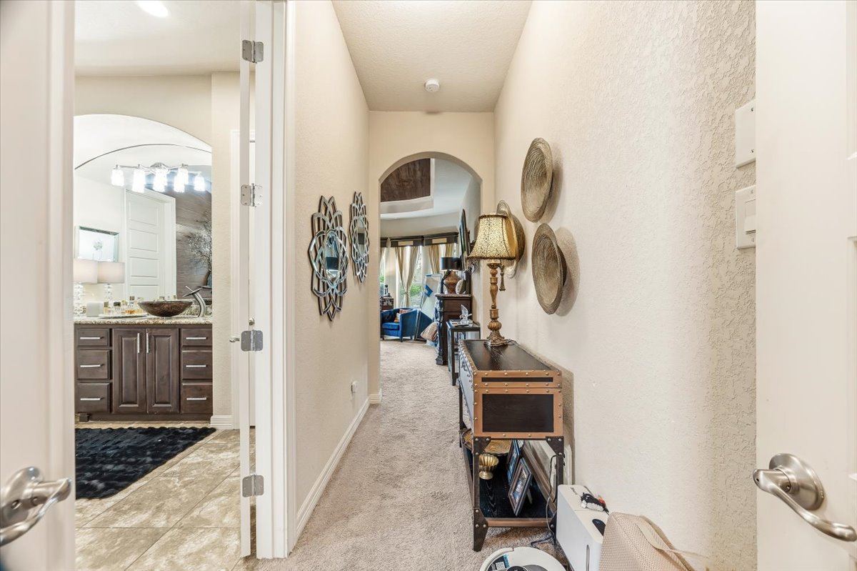 1930 Rothschild New Braunfels, TX 78132 - Photo 22 of 39 This property offers a hallway with carpeted flooring leading to a bathroom featuring a dark wood vanity with a vessel sink and a tiled floor