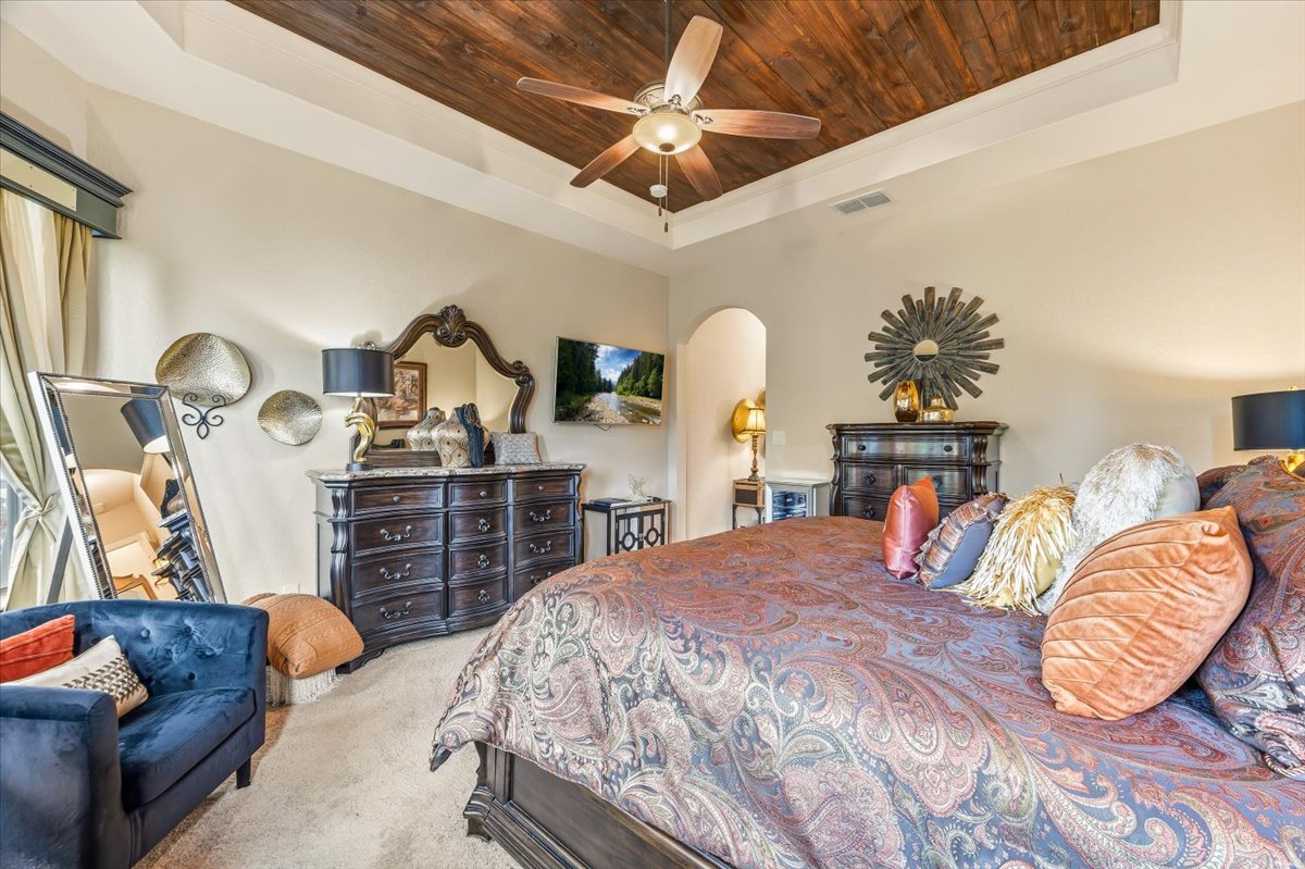 1930 Rothschild New Braunfels, TX 78132 - Photo 24 of 39 This spacious room features a tray ceiling with wood paneling and a ceiling fan