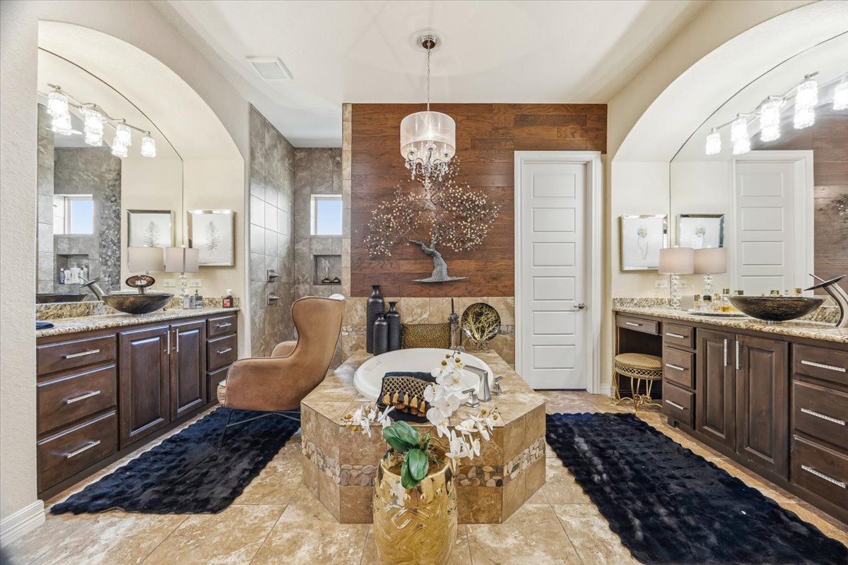 1930 Rothschild New Braunfels, TX 78132 - Photo 25 of 39 Spacious bathroom featuring a built-in tub, dual vanity with vessel sinks, and tile flooring