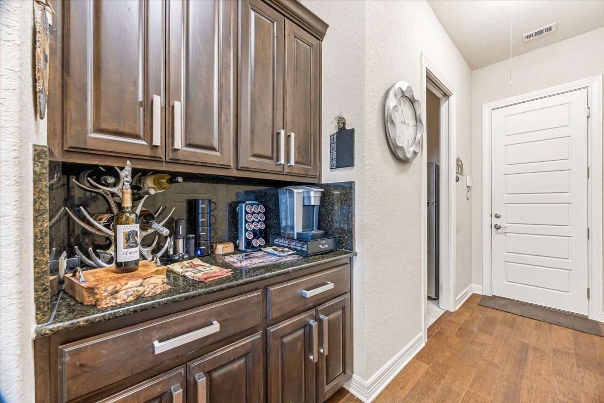1930 Rothschild New Braunfels, TX 78132 - Photo 28 of 39 Custom cabinetry with granite countertops, providing both storage and a dedicated beverage station