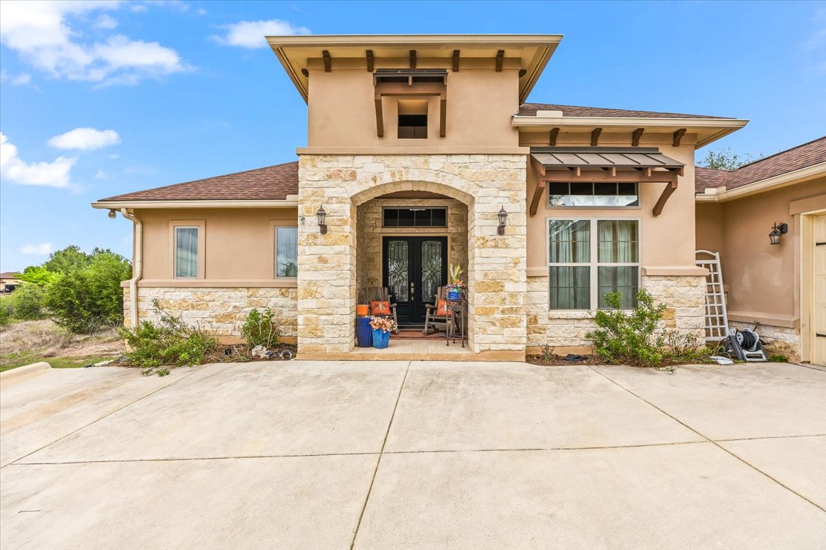 1930 Rothschild New Braunfels, TX 78132 - Photo 3 of 39 The property features an inviting entrance with a stone-accented facade and a covered porch