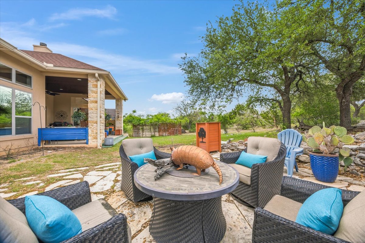 1930 Rothschild New Braunfels, TX 78132 - Photo 33 of 39 The property includes an outdoor patio area with stone paving, surrounded by lush green grass and mature trees