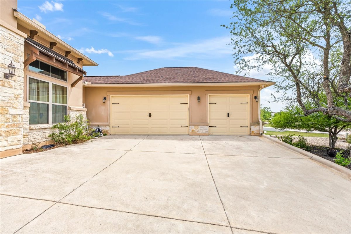 1930 Rothschild New Braunfels, TX 78132 - Photo 35 of 39 The property features a concrete driveway leading to a two-car garage with light-colored doors