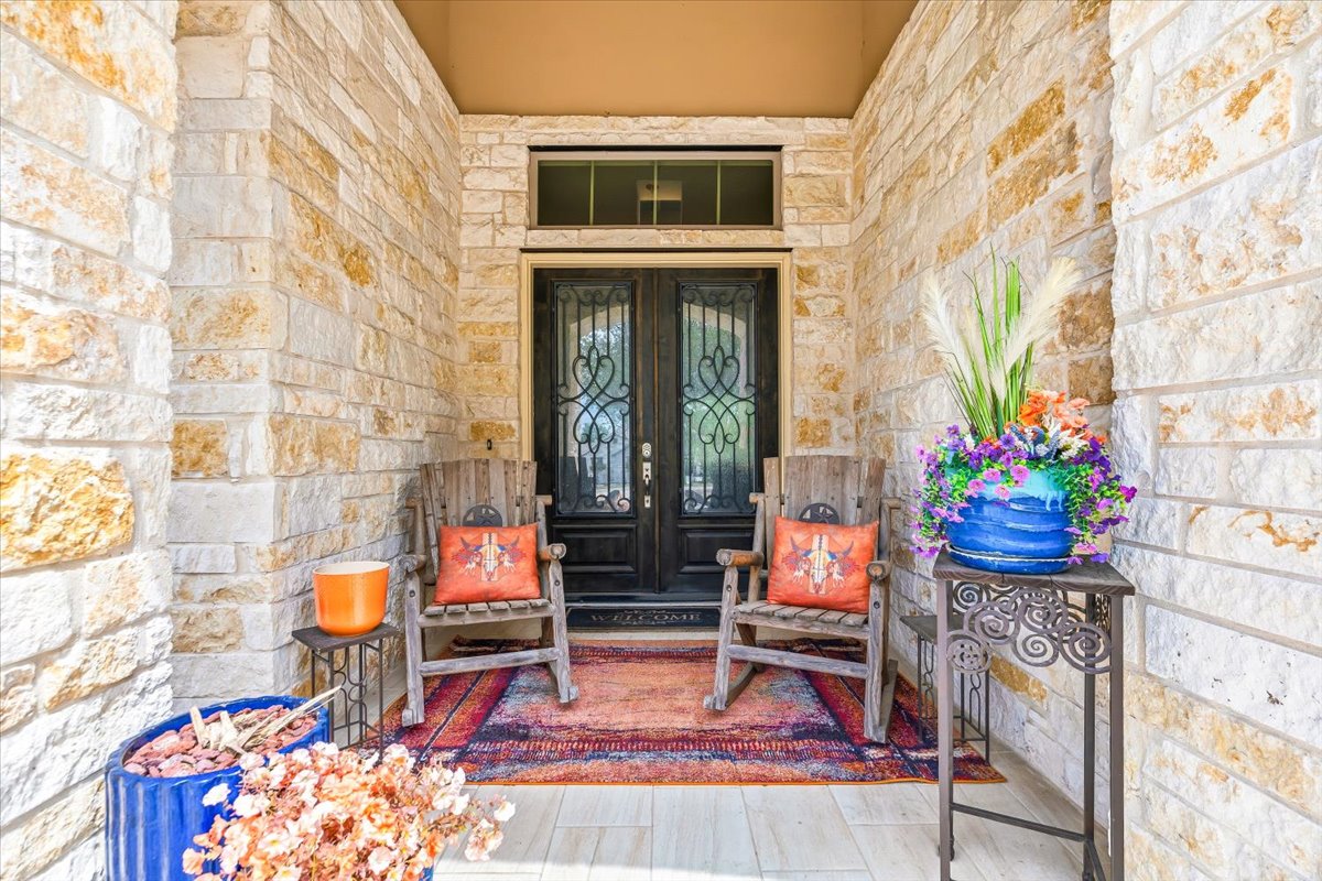 1930 Rothschild New Braunfels, TX 78132 - Photo 5 of 39 The property features a stone facade and a welcoming entryway with a double door entry