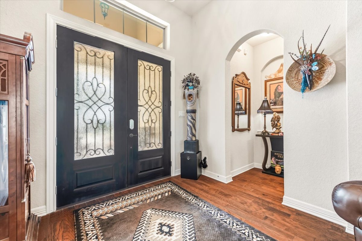 1930 Rothschild New Braunfels, TX 78132 - Photo 7 of 39 The entry features hardwood floors and a dark double door with decorative glass inserts