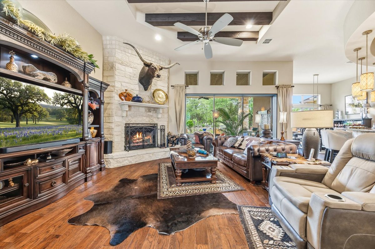 1930 Rothschild New Braunfels, TX 78132 - Photo 8 of 39 This inviting living space features hardwood floors, a stone fireplace, and a ceiling fan