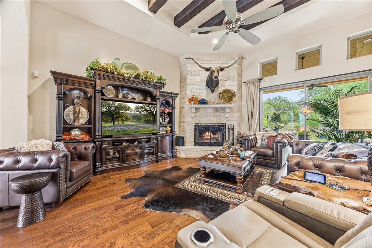 1930 Rothschild New Braunfels, TX 78132 - Photo 10 of 39 This living area features hardwood floors and a stone fireplace