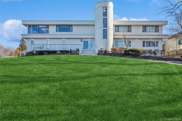 a front view of a house with a garden and plants