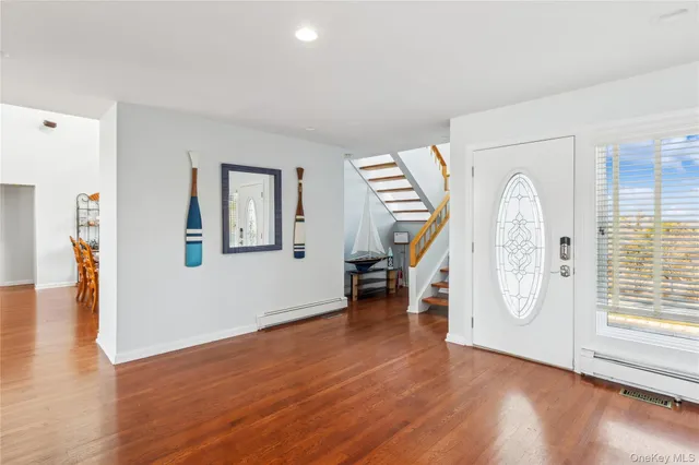 a view of an empty room with window wooden floor and a ceiling fan