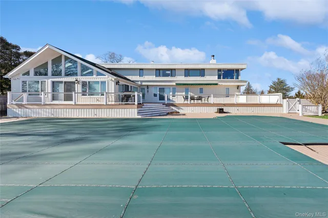 a front view of a house with a yard table and chairs