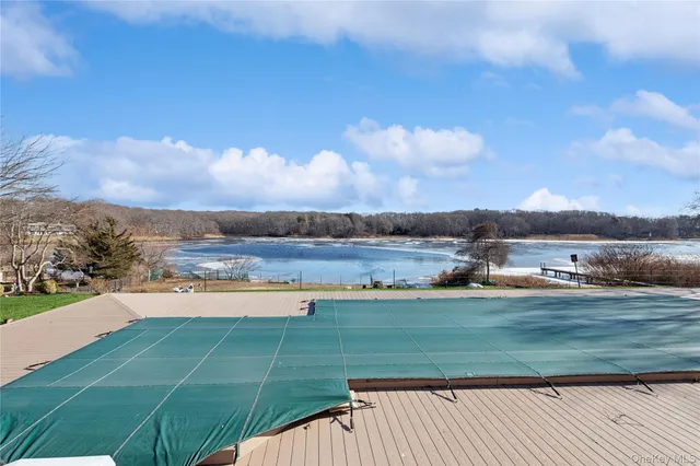 a view of a lake with houses in the back