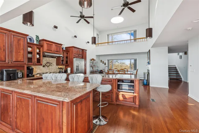 a kitchen with stainless steel appliances granite countertop a stove and refrigerator