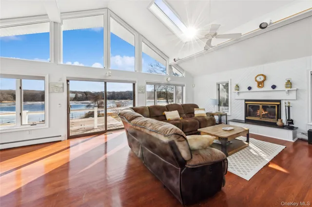 a living room with furniture large window and a fireplace