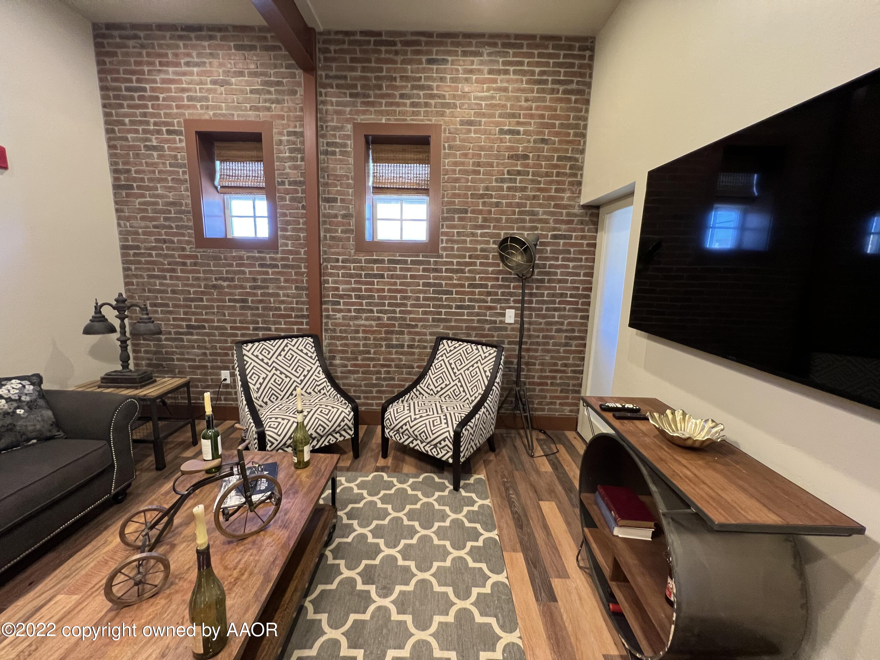 Southeast 10th Amarillo, TX 79101 - Photo 5 of 10 a view of a livingroom with furniture and a flat screen tv