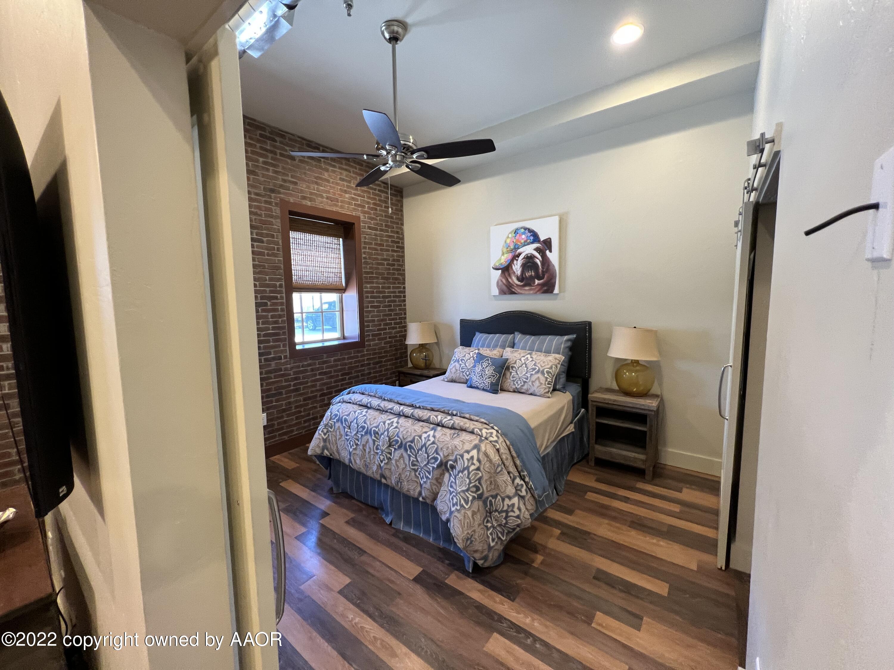 Southeast 10th Amarillo, TX 79101 - Photo 6 of 10 a bedroom with a bed and a chandelier