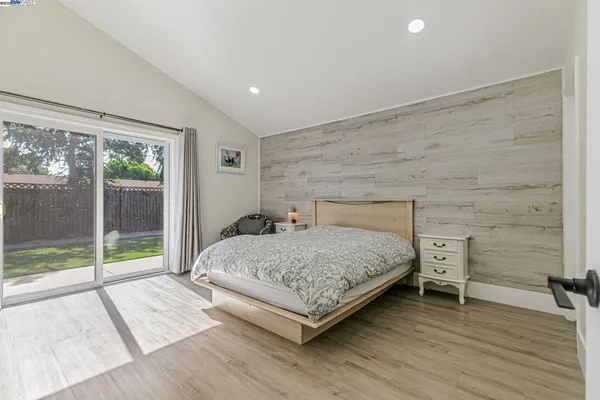 a bedroom with a bed and a couch