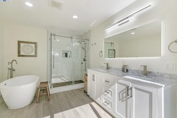 a spacious bathroom with a granite countertop sink mirror and shower