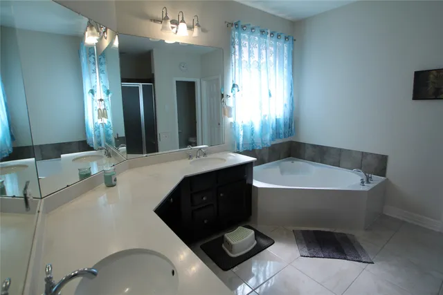 a bathroom with a sink vanity and mirror
