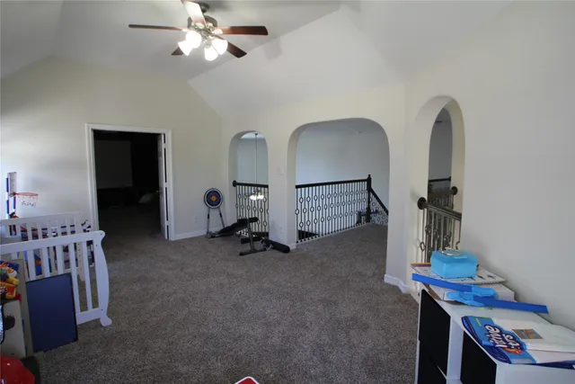 a room with a bed window and dresser