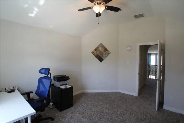 a spacious bedroom with a bed and a window