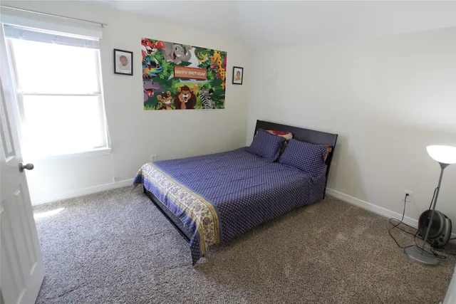 a bedroom with a bed and a dresser