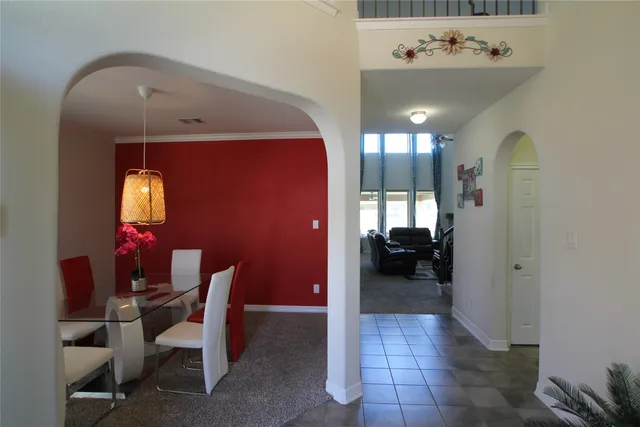 a view of a hallway with workspace and a window