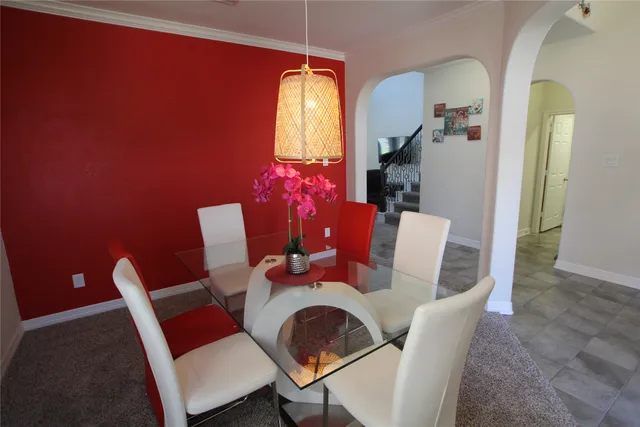 a dining room with furniture and window