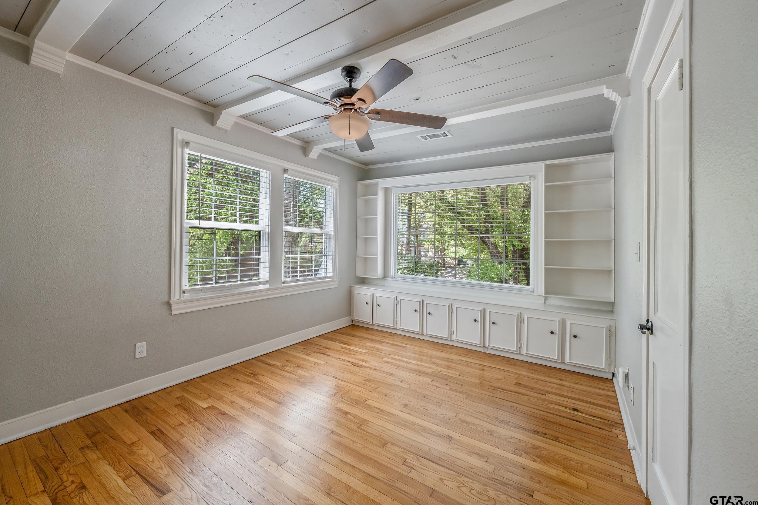 434 South Vine Avenue Tyler, TX 75702 - Photo 14 of 29 a view of an empty room with wooden floor and a window