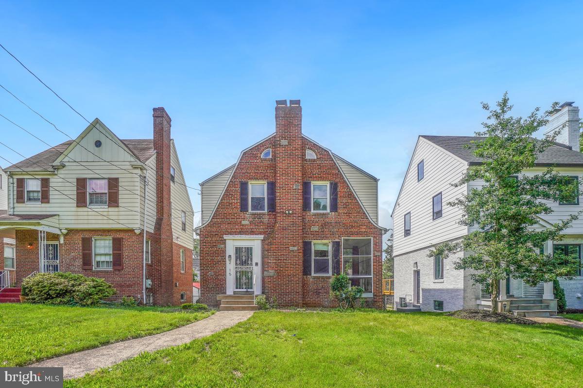 a front view of a brick house with a yard