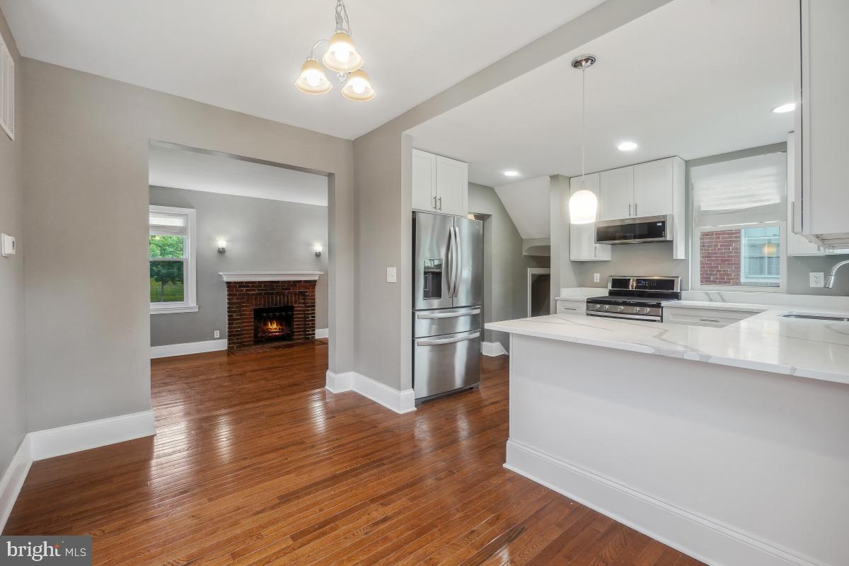2615 Otis Street Northeast Washington, DC 20018 - Photo 11 of 45 a view of kitchen with refrigerator stove and wooden floor