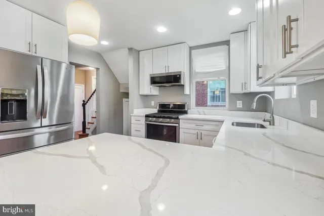 a kitchen with a sink stainless steel appliances and cabinets