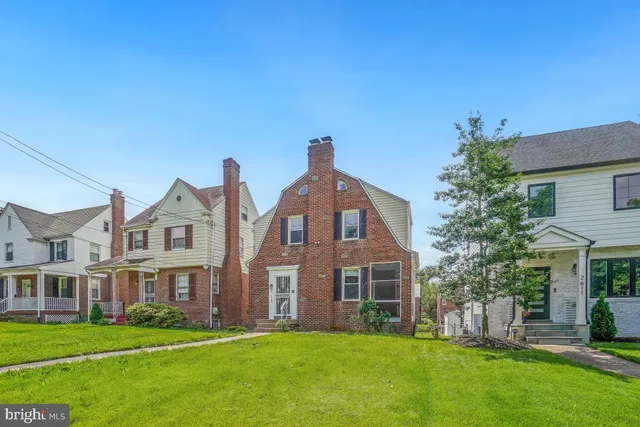 a front view of house with yard and green space