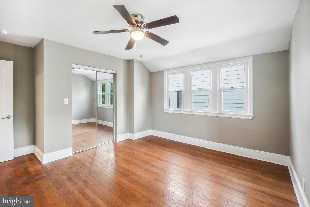2615 Otis Street Northeast Washington, DC 20018 - Photo 31 of 45 a view of an empty room with wooden floor and a window
