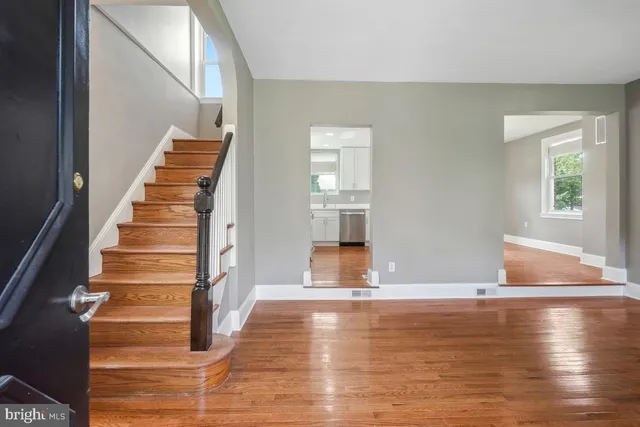 a view of entryway and hall with wooden floor