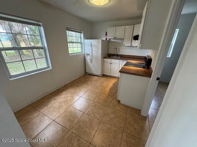 a kitchen with a refrigerator and window