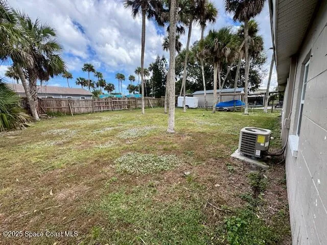 a view of a chair and table in the backyard
