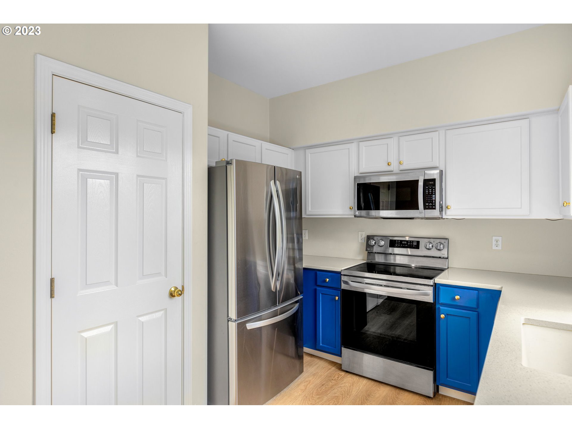 15530 Southwest Peridot Way Beaverton, OR 97007 - Photo 8 of 31 a kitchen with stainless steel appliances a stove a microwave and a refrigerator