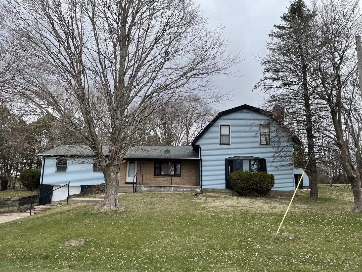 26644 Avers Road Sterling, IL 61081 - Photo 1 of 19 a front view of house with yard and trees in the background