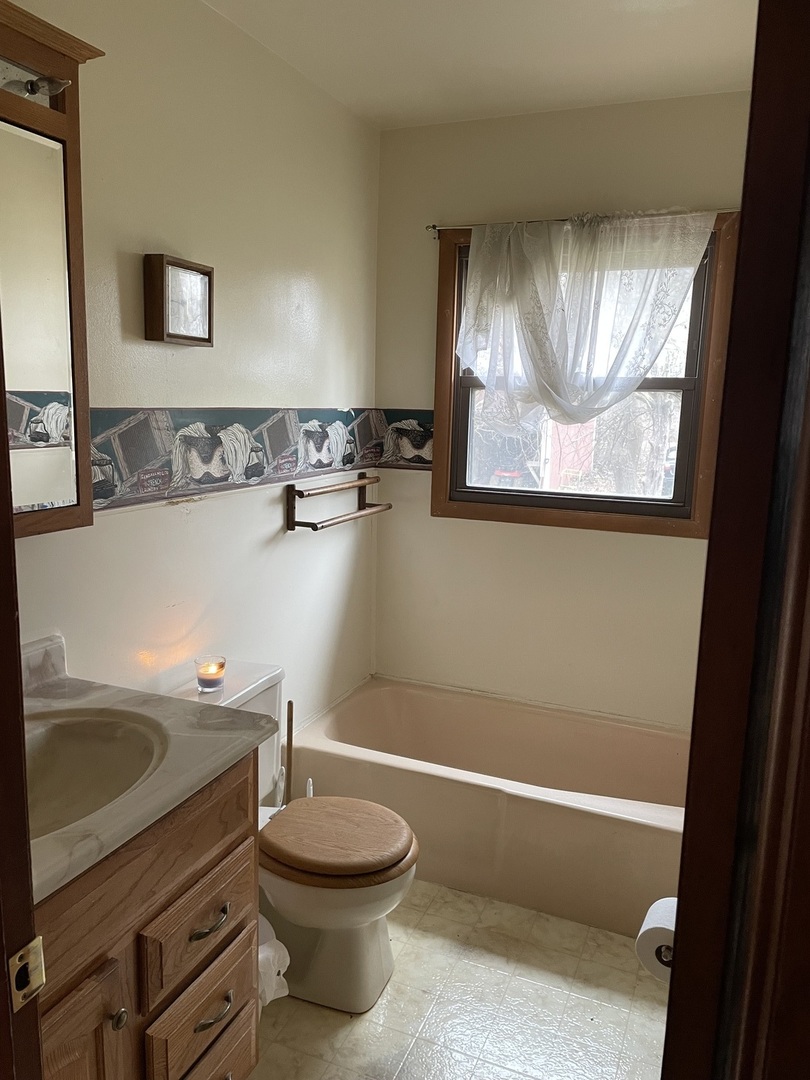 26644 Avers Road Sterling, IL 61081 - Photo 14 of 19 a bathroom with a toilet a sink and bathtub