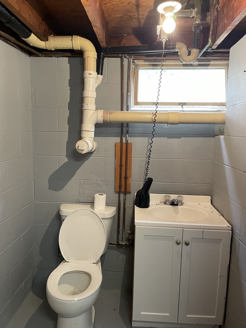 26644 Avers Road Sterling, IL 61081 - Photo 15 of 19 a bathroom with a toilet a sink and a window