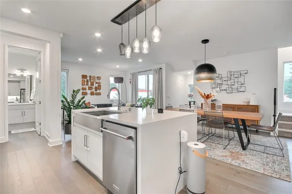 a kitchen that has a lot of cabinets in it and wooden floors
