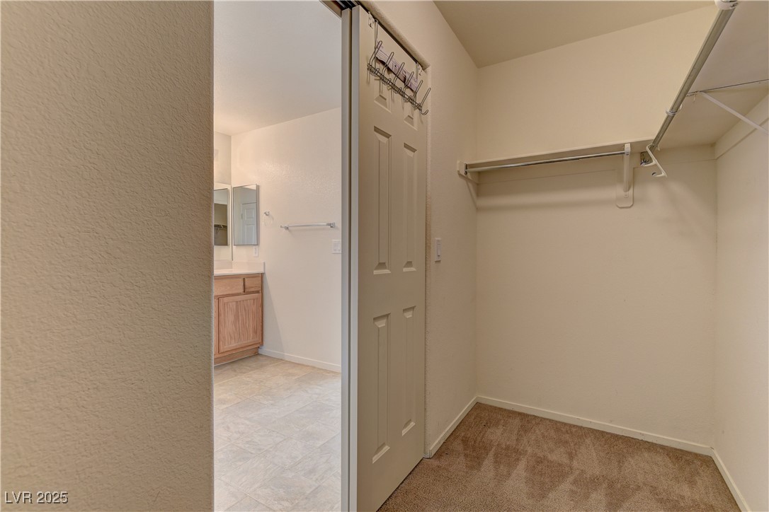 10403 Madagascar Palm Street Las Vegas, NV 89141 - Photo 17 of 21 Walk in closet featuring light colored carpet