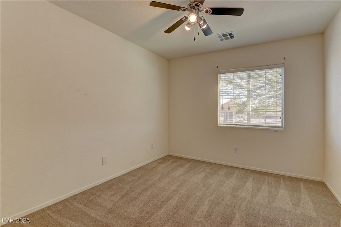 10403 Madagascar Palm Street Las Vegas, NV 89141 - Photo 19 of 21 Empty room with light colored carpet and a ceiling fan