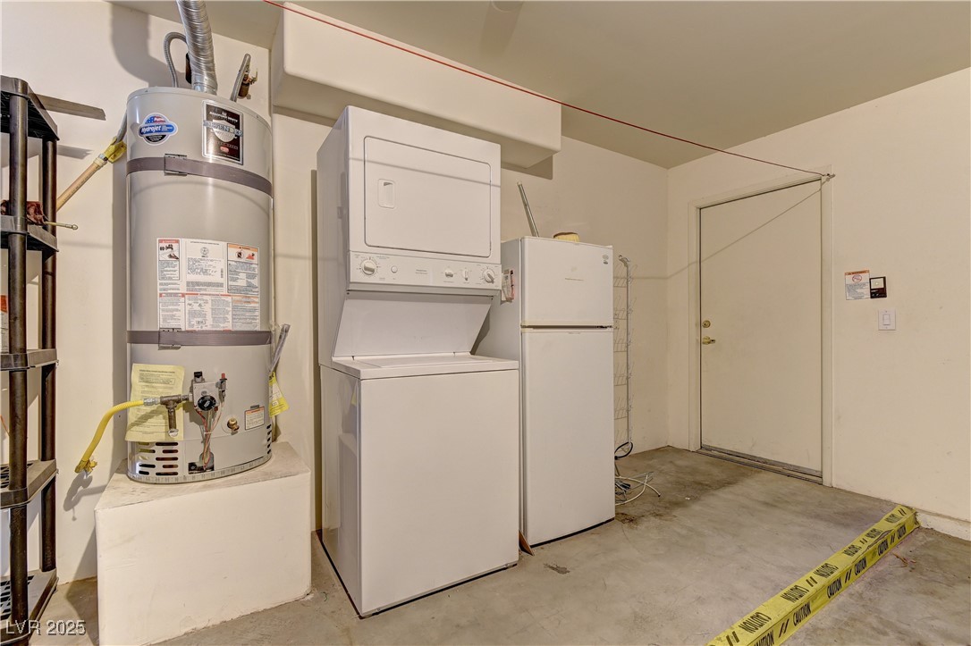 10403 Madagascar Palm Street Las Vegas, NV 89141 - Photo 21 of 21 Washroom with secured water heater, unfinished concrete floors, and stacked washer / dryer